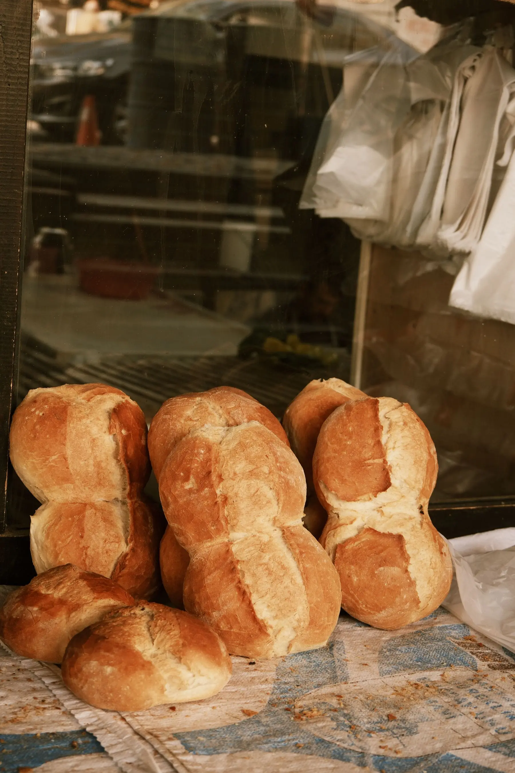 A close view of crusty bread rolls with a floured, golden crust.