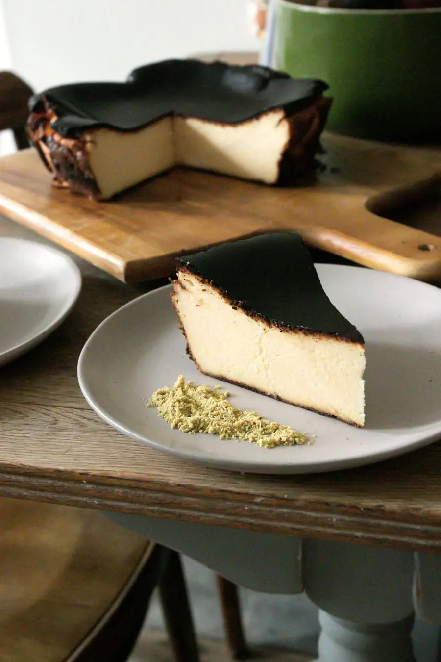 A slice of Basque cheesecake with a burnt top and a soft centre.