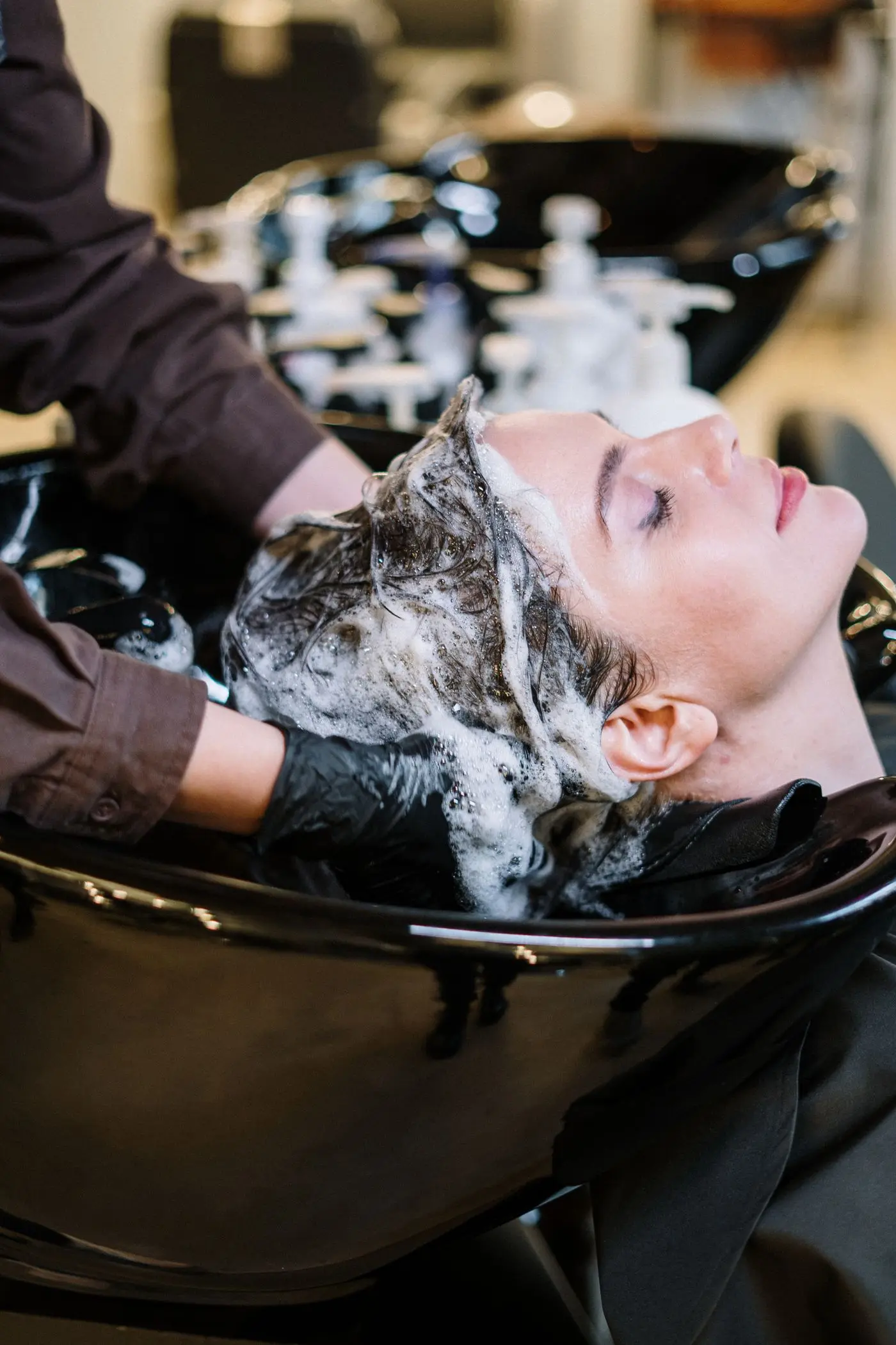 A client relaxing at the basin while her hair is washed.